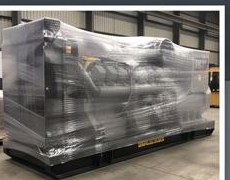 Photograph of one of the units in a warehouse, still on its shipping pallet and sealed in factory shrink-wrap.